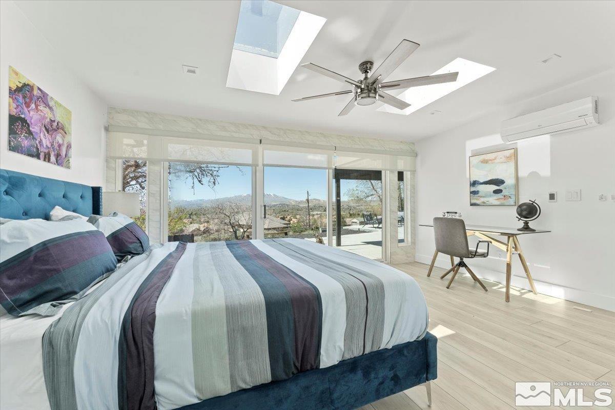 2665 Westview Boulevard Sparks, NV 89434 - Photo 18 of 33 a spacious bedroom with a large bed and a chandelier