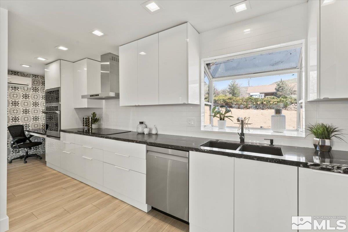 2665 Westview Boulevard Sparks, NV 89434 - Photo 9 of 33 a kitchen with stainless steel appliances granite countertop a sink a stove and a wooden floors