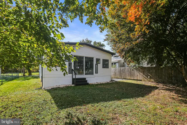 a front view of house with a garden