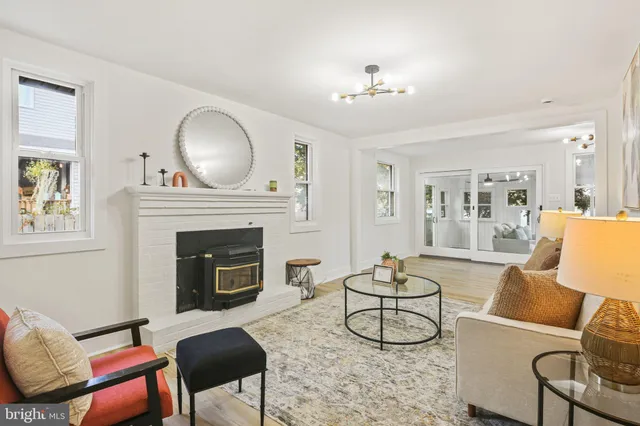 a living room with furniture a fireplace and wooden floor