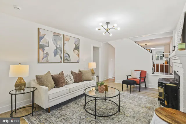 a living room with furniture a rug and a chandelier