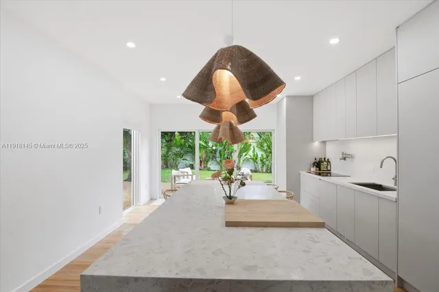 a kitchen with stainless steel appliances granite countertop a stove and a wooden floors