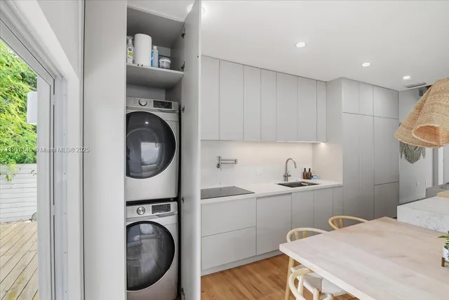 a kitchen with a sink cabinets and a window