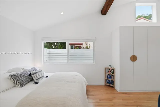 a bedroom with furniture and a window