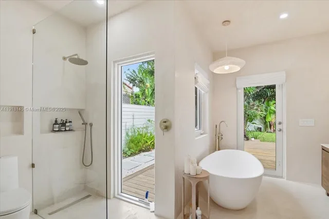 a bathroom with a double vanity sink mirror and toilet