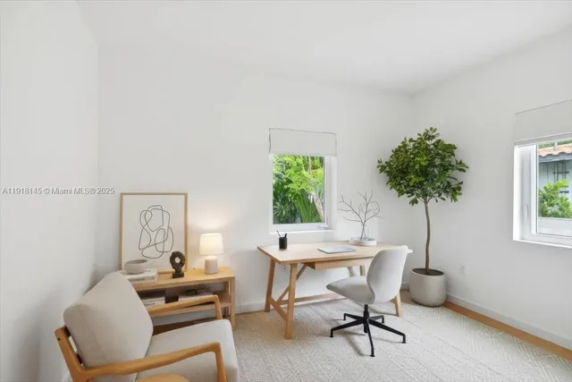 a view of a patio with table and chairs and potted plants with large tree
