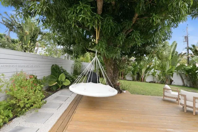 a view of a yard with flower plants