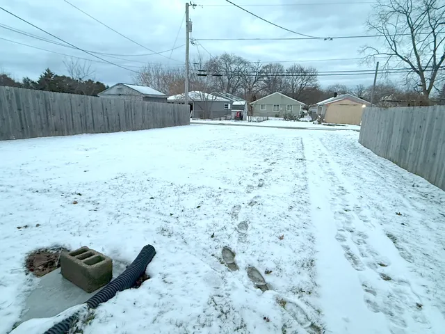 a view of outdoor space with wooden fence