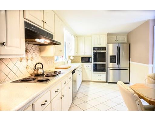 250 Edgewater Drive Needham, MA 02492 - Photo 10 of 27 a kitchen with stainless steel appliances a sink a stove and a refrigerator