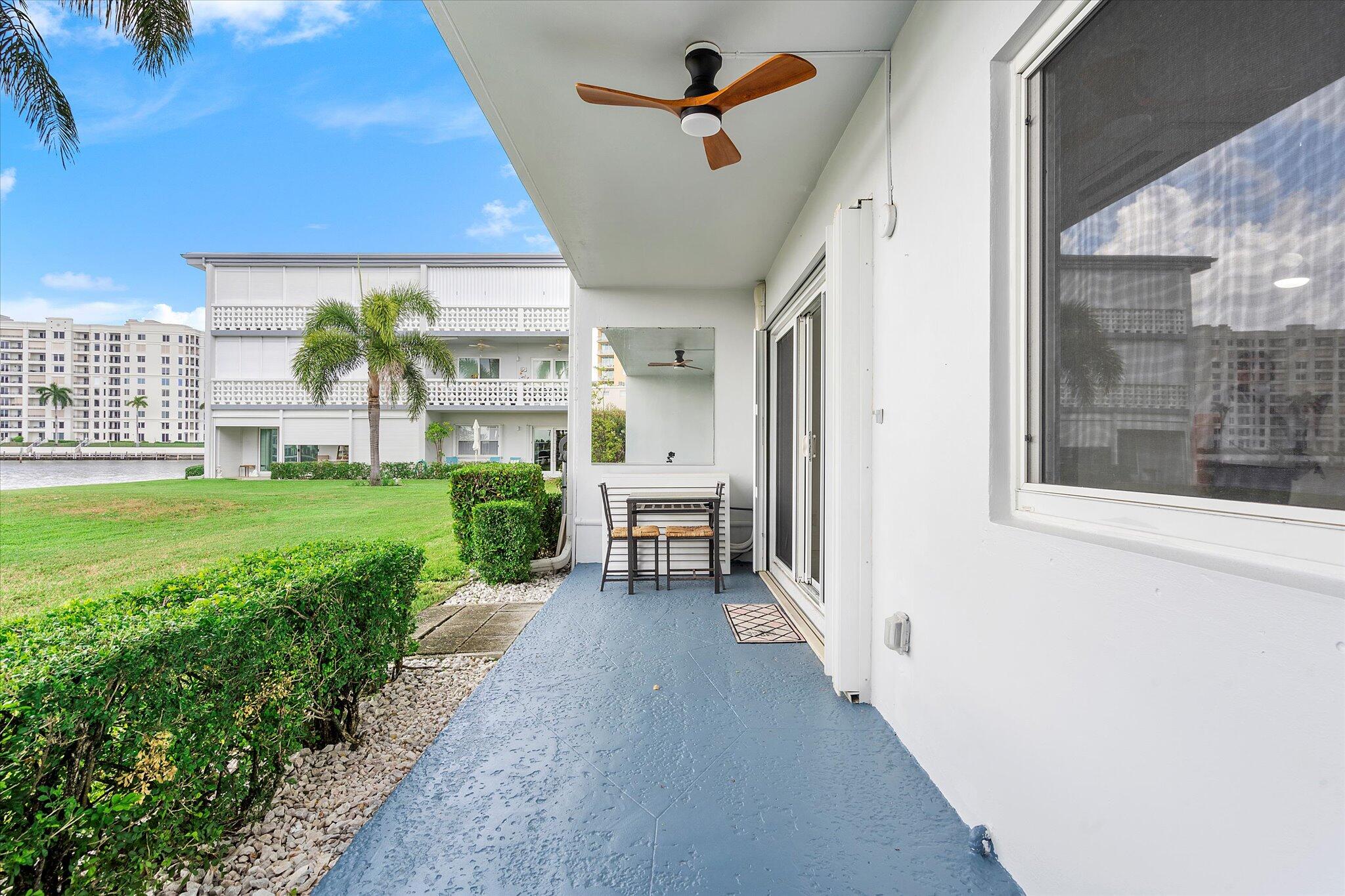 1001 North Riverside Drive, Unit 104 Pompano Beach, FL 33062 - Photo 11 of 17 a view of a porch with a table and chairs