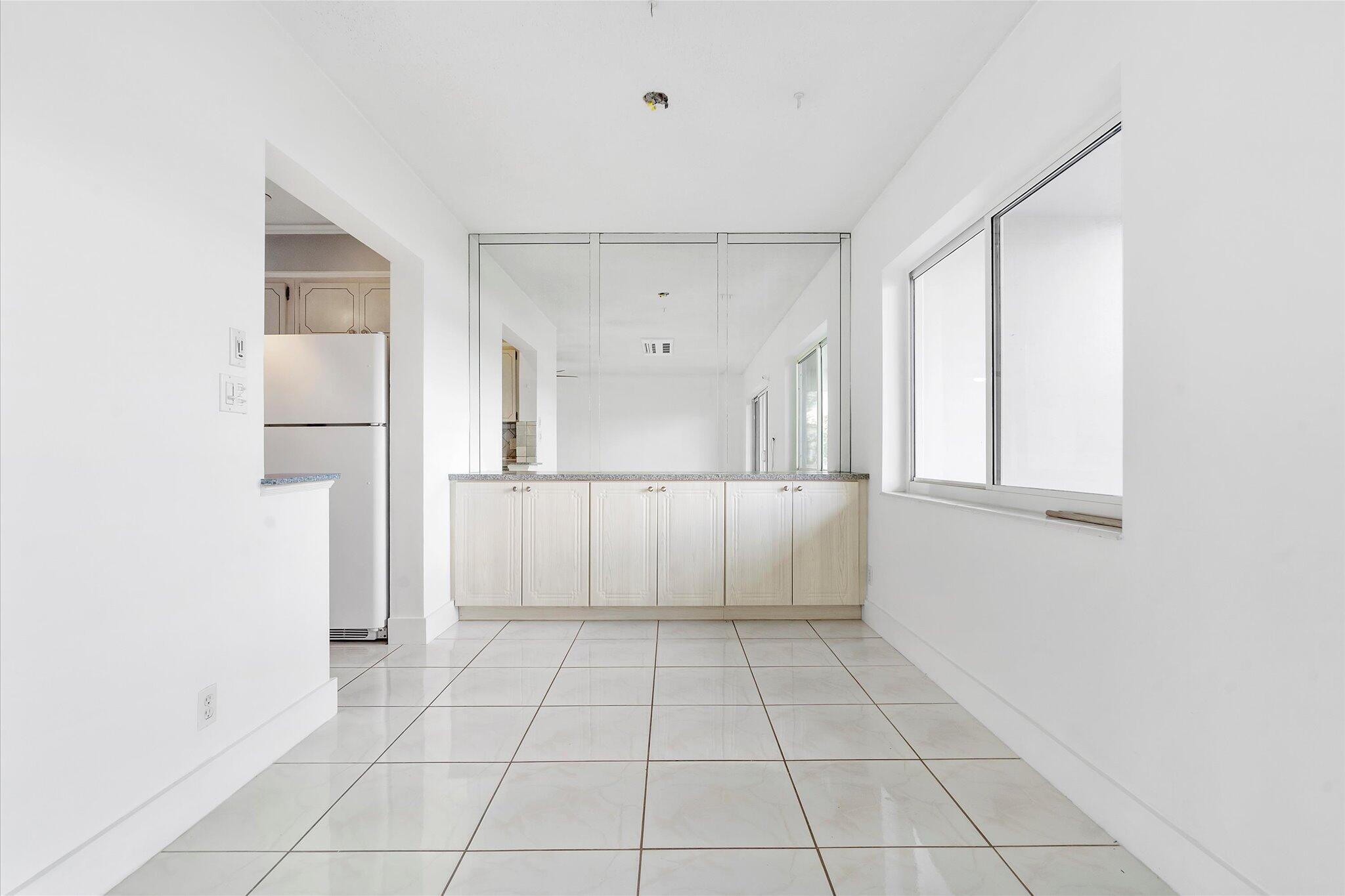 1001 North Riverside Drive, Unit 104 Pompano Beach, FL 33062 - Photo 5 of 17 a view of an empty room with a window