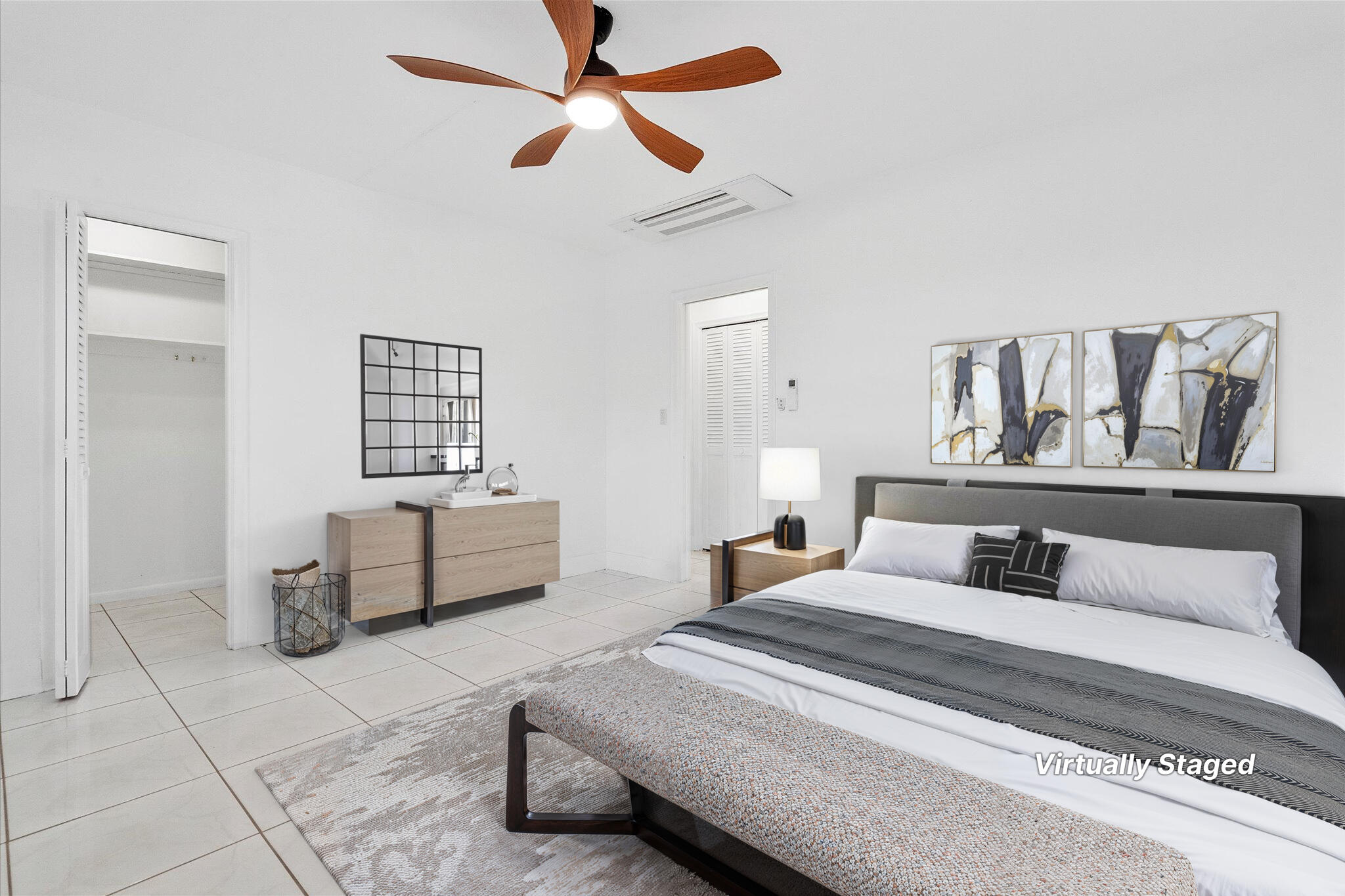 1001 North Riverside Drive, Unit 104 Pompano Beach, FL 33062 - Photo 7 of 17 a bedroom with a large bed and a chandelier