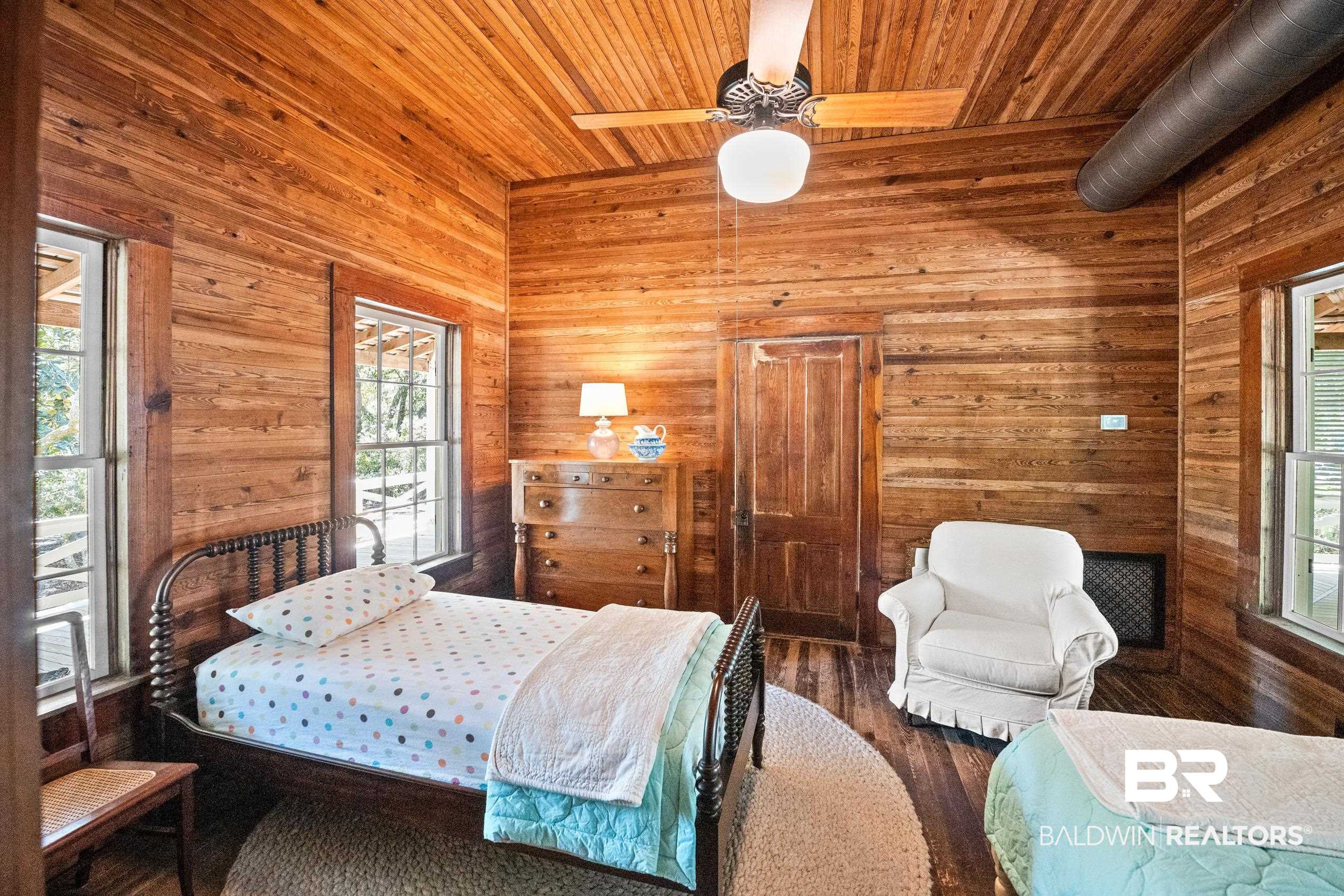30671 Magnolia Street Elberta, AL 36530 - Photo 34 of 68 Bedroom featuring wooden walls, wood finished floors, and wood ceiling