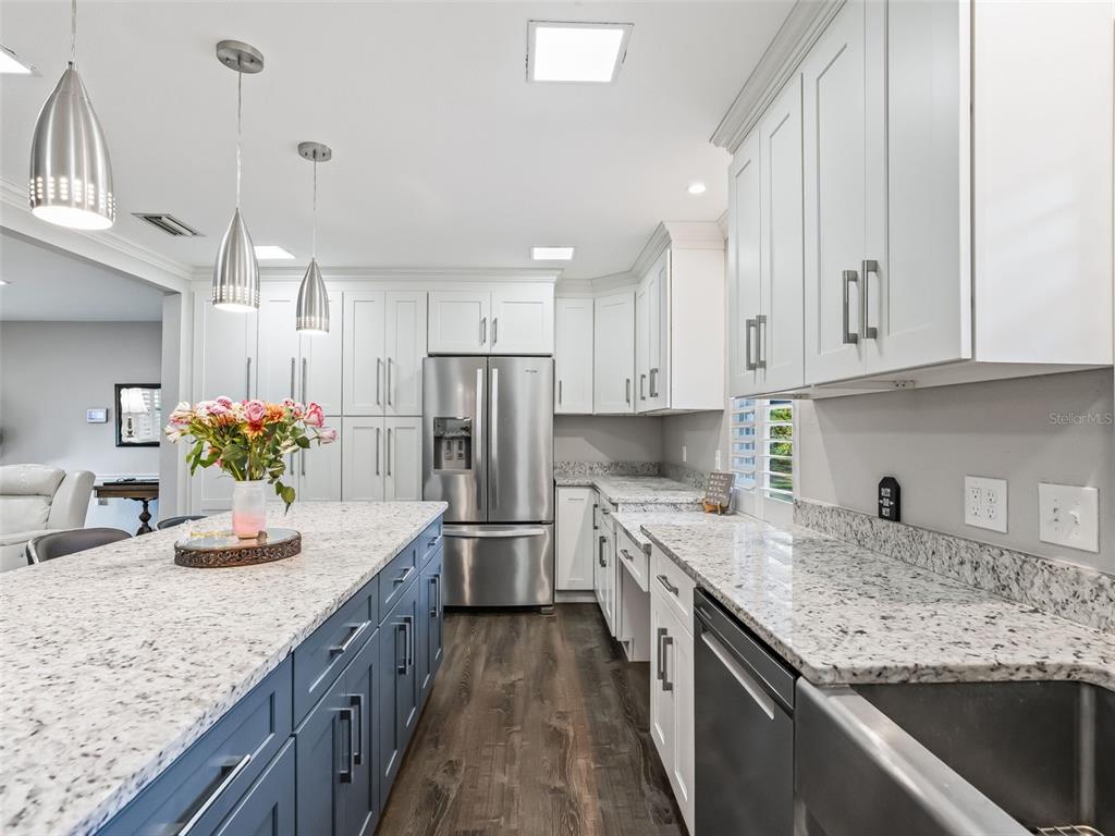 3505 Northeast 97th Street Road Anthony, FL 32617 - Photo 11 of 38 a kitchen with stainless steel appliances granite countertop a sink stove and refrigerator