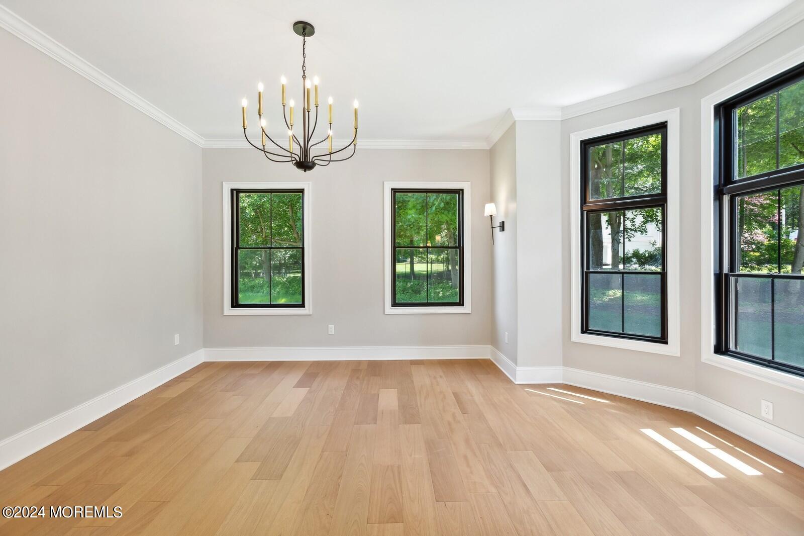 16 Round Hill Holmdel, NJ 07733 - Photo 7 of 60 a view of an empty room with wooden floor and a window