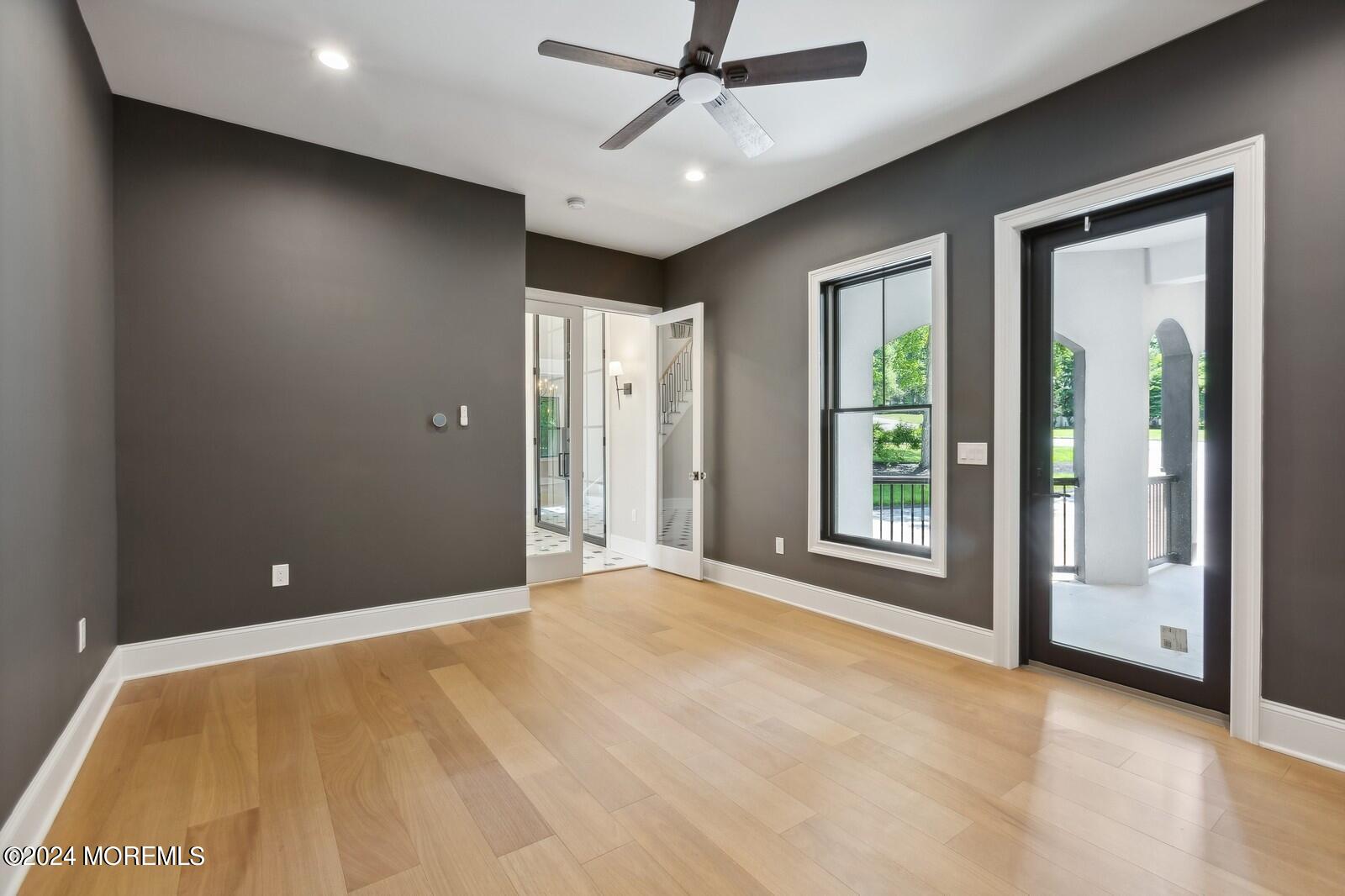 16 Round Hill Holmdel, NJ 07733 - Photo 8 of 60 a view of a livingroom with a ceiling fan and window