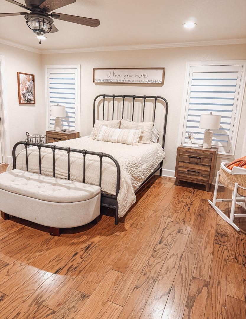 2253 Buffalo Way Copperopolis, CA 95228 - Photo 19 of 39 a spacious bedroom with a bed a couch and a window