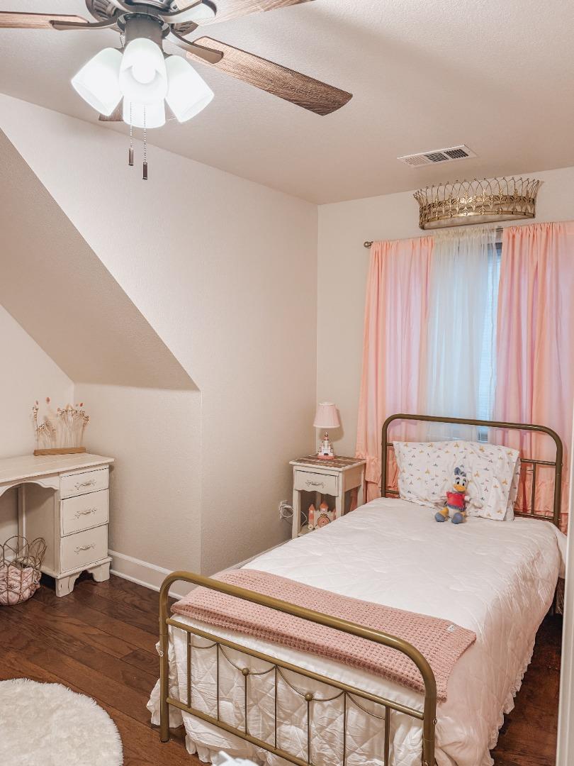 2253 Buffalo Way Copperopolis, CA 95228 - Photo 22 of 39 a bedroom with a bed and a chandelier