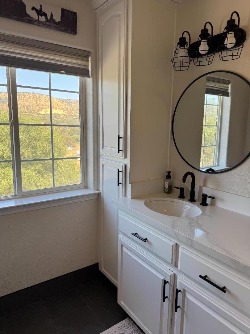 2253 Buffalo Way Copperopolis, CA 95228 - Photo 26 of 39 a bathroom with a sink a vanity and a mirror