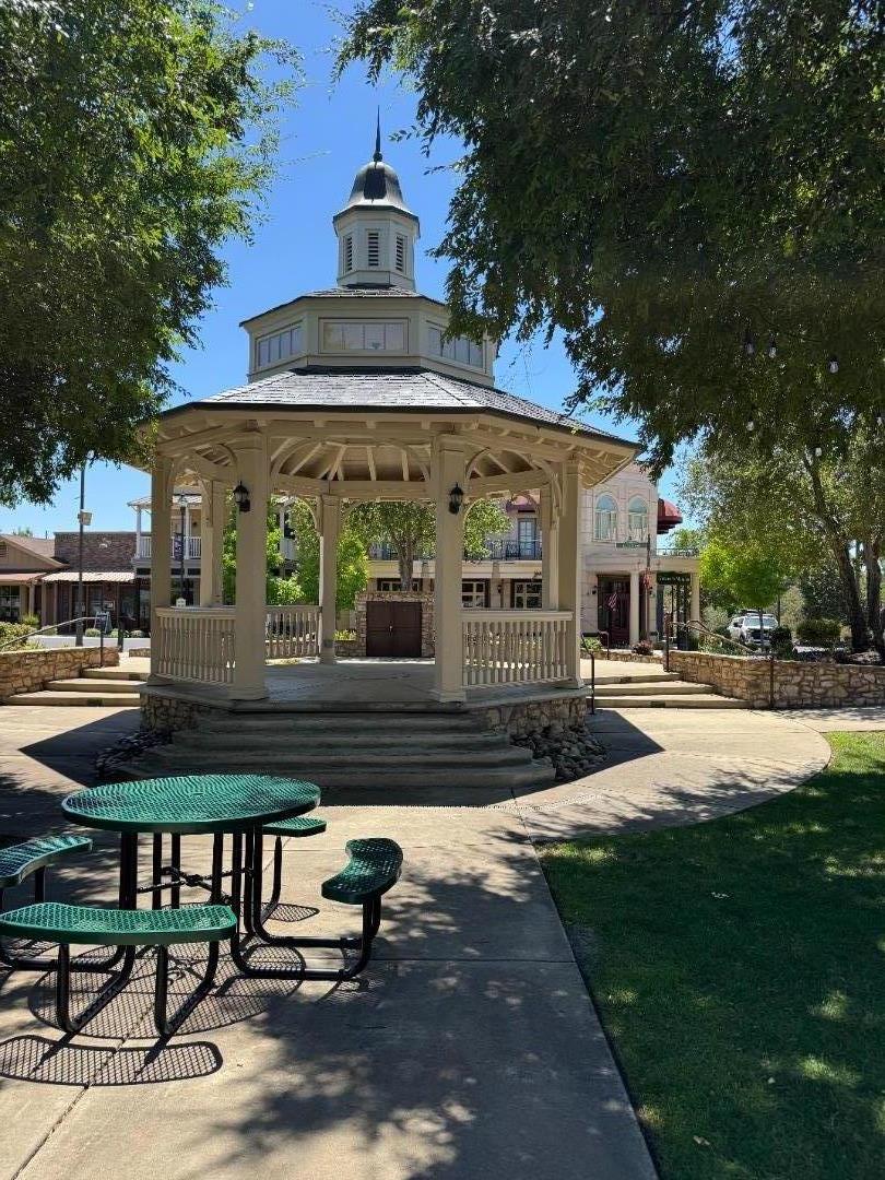 2253 Buffalo Way Copperopolis, CA 95228 - Photo 37 of 39 a view of a patio with table and chairs with wooden floor and fence