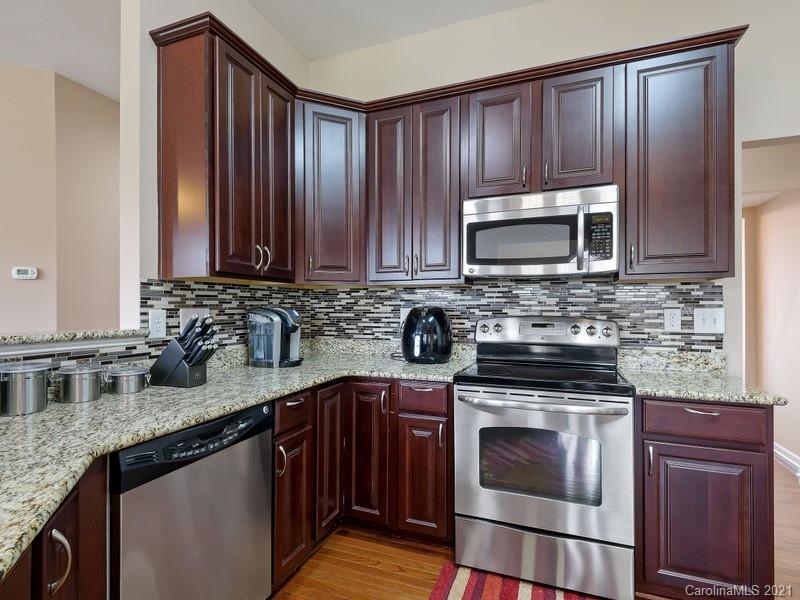 7726 Wiltshire Ridge Road Charlotte, NC 28269 - Photo 11 of 26 a kitchen with granite countertop wooden cabinets and stainless steel appliances