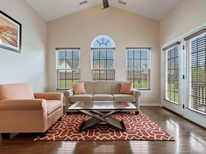 7726 Wiltshire Ridge Road Charlotte, NC 28269 - Photo 12 of 26 a living room with furniture and a floor to ceiling window