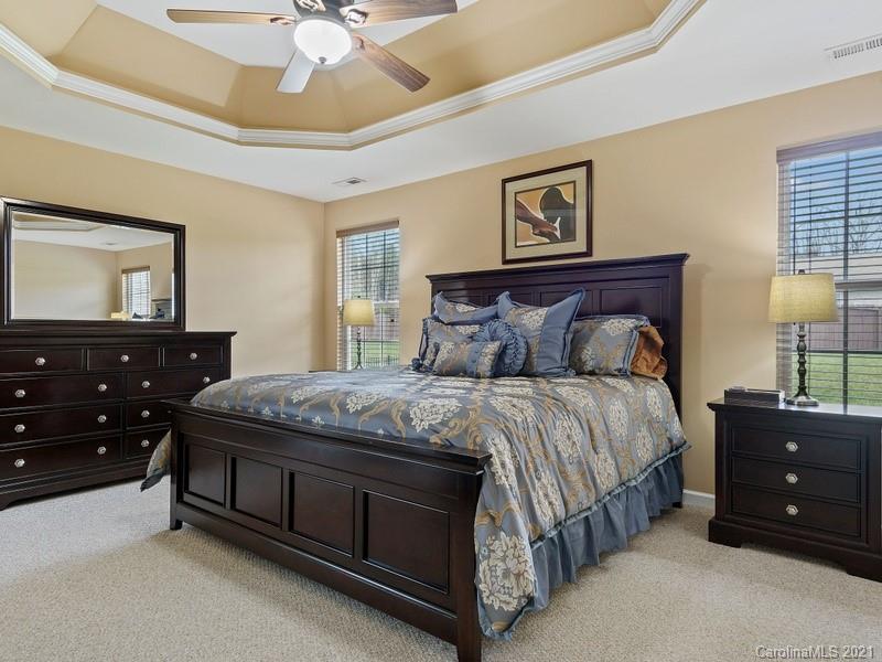 7726 Wiltshire Ridge Road Charlotte, NC 28269 - Photo 13 of 26 a bedroom with a bed and a dresser