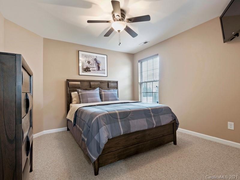 7726 Wiltshire Ridge Road Charlotte, NC 28269 - Photo 14 of 26 a spacious bedroom with a bed and a ceiling fan