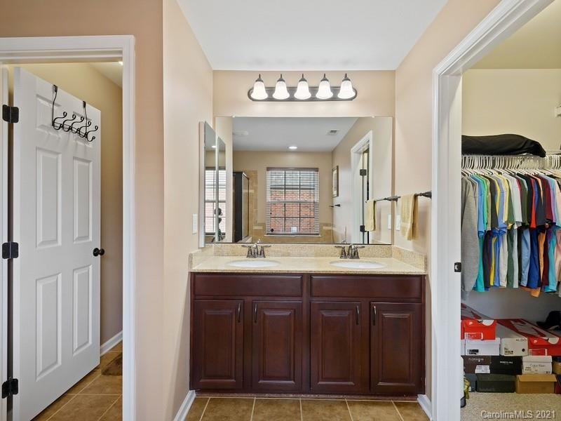 7726 Wiltshire Ridge Road Charlotte, NC 28269 - Photo 15 of 26 a bathroom with a sink a large mirror and a shower