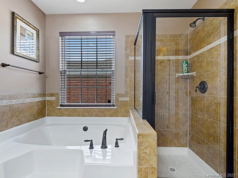 7726 Wiltshire Ridge Road Charlotte, NC 28269 - Photo 17 of 26 a bathroom with a bathtub and shower
