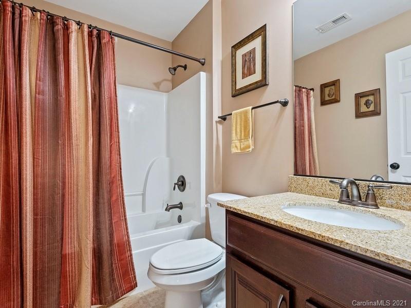 7726 Wiltshire Ridge Road Charlotte, NC 28269 - Photo 19 of 26 a bathroom with a granite countertop sink toilet and shower