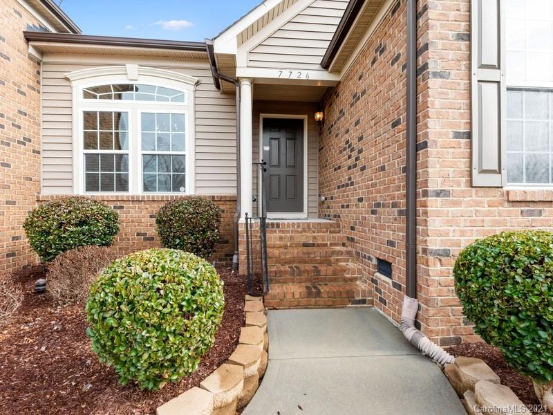 7726 Wiltshire Ridge Road Charlotte, NC 28269 - Photo 3 of 26 a front view of a house with a lots of potted plants