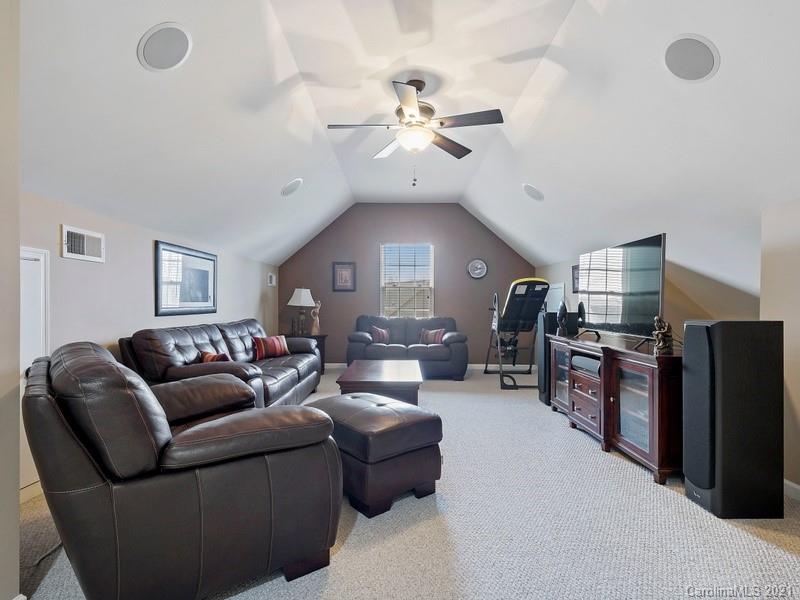 7726 Wiltshire Ridge Road Charlotte, NC 28269 - Photo 21 of 26 a living room with furniture and a chandelier