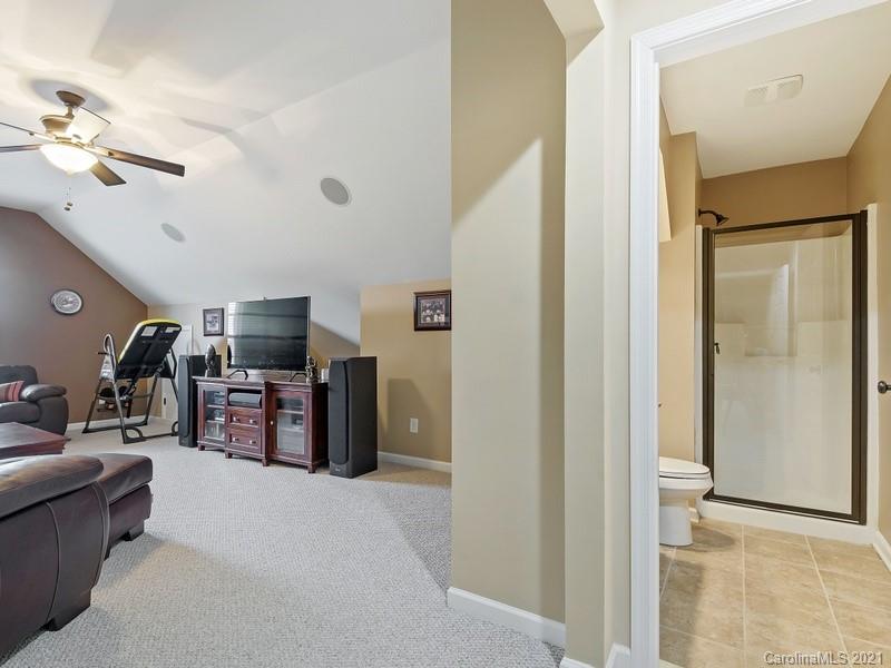 7726 Wiltshire Ridge Road Charlotte, NC 28269 - Photo 22 of 26 a view of a livingroom with furniture and a flat screen tv