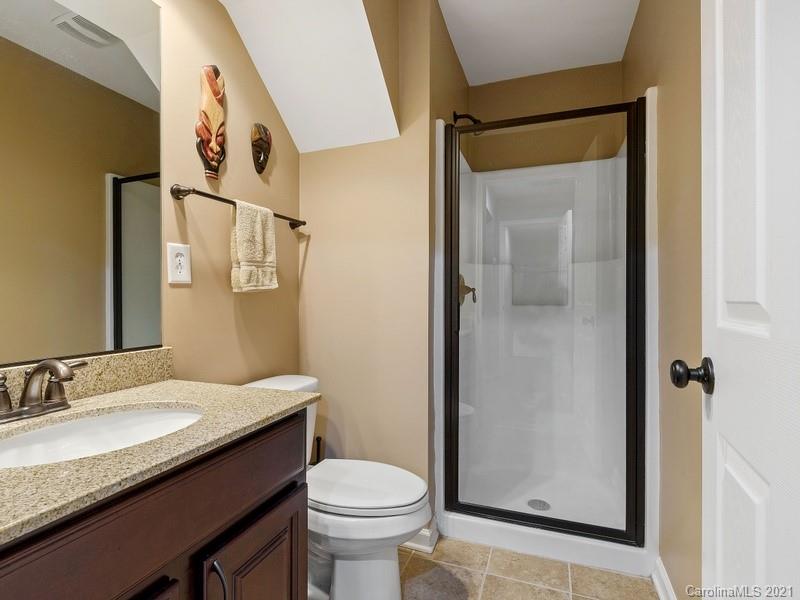 7726 Wiltshire Ridge Road Charlotte, NC 28269 - Photo 23 of 26 a bathroom with a granite countertop sink toilet and shower