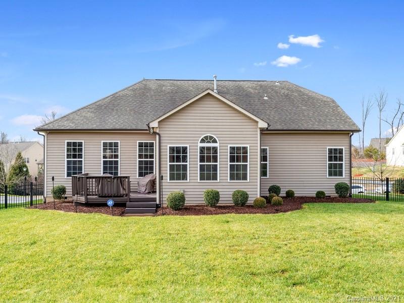 7726 Wiltshire Ridge Road Charlotte, NC 28269 - Photo 24 of 26 a front view of a house with a yard and outdoor seating