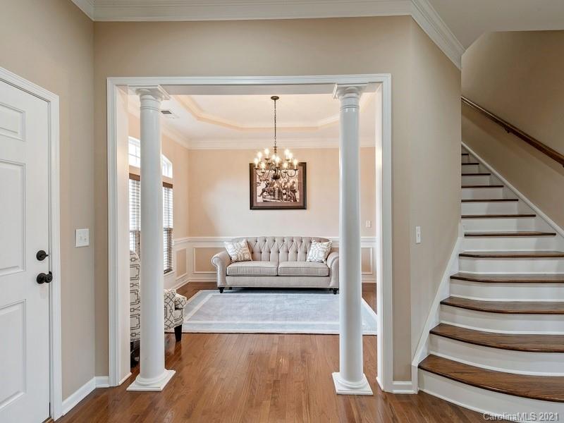 7726 Wiltshire Ridge Road Charlotte, NC 28269 - Photo 5 of 26 a view of a hallway with wooden floor and a chandelier