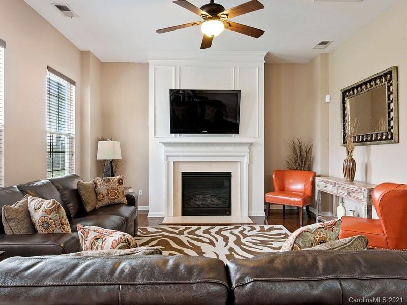 7726 Wiltshire Ridge Road Charlotte, NC 28269 - Photo 7 of 26 a living room with furniture and a fireplace