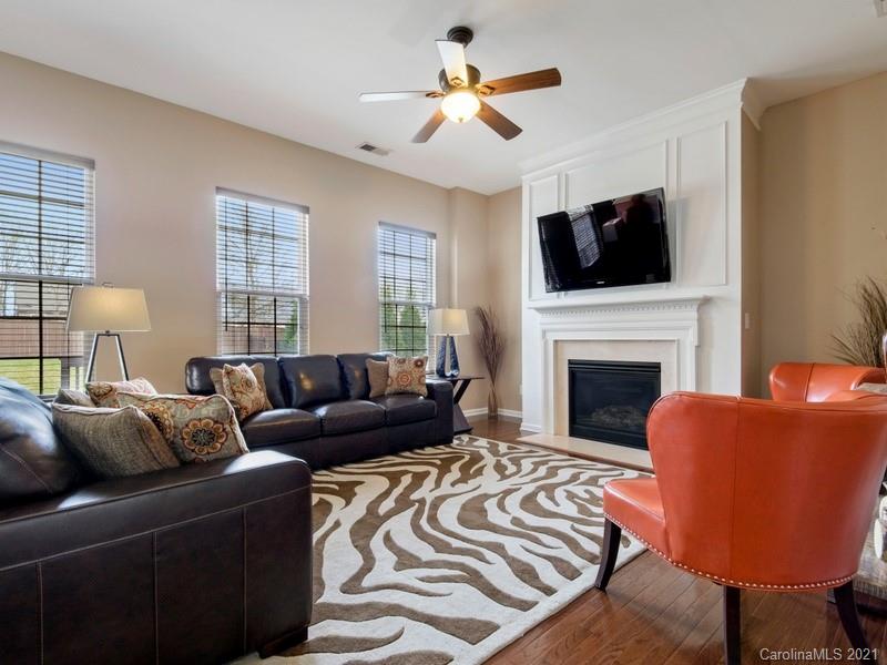 7726 Wiltshire Ridge Road Charlotte, NC 28269 - Photo 8 of 26 a living room with furniture a fireplace and a flat screen tv