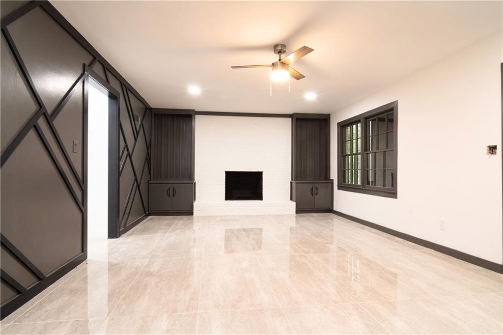 69 Hearn Road Ellenwood, GA 30294 - Photo 12 of 19 a view of an empty room with wooden floor and a window