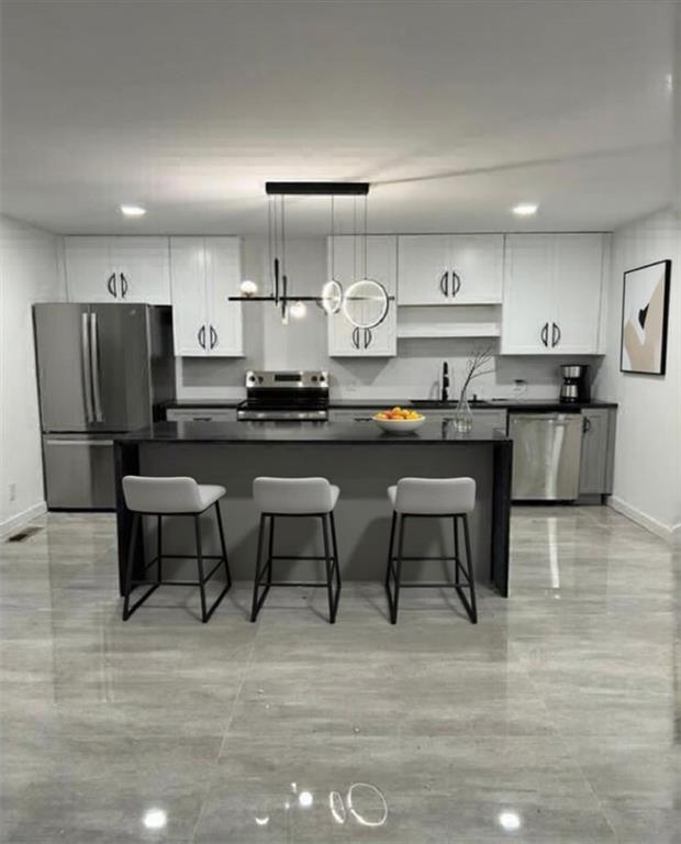 69 Hearn Road Ellenwood, GA 30294 - Photo 17 of 19 a kitchen with stainless steel appliances kitchen island granite countertop a table chairs microwave and sink