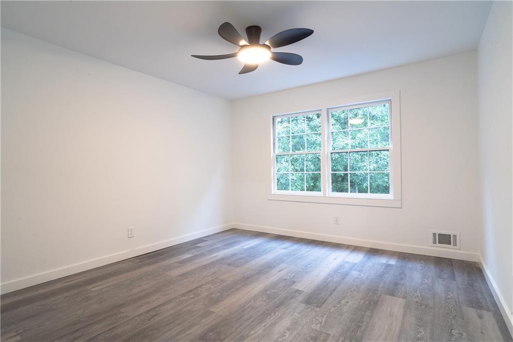 69 Hearn Road Ellenwood, GA 30294 - Photo 6 of 19 a view of an empty room with wooden floor and a window
