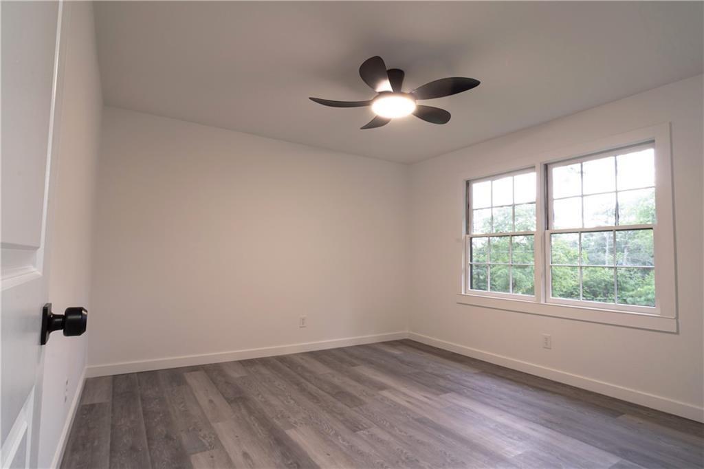 69 Hearn Road Ellenwood, GA 30294 - Photo 8 of 19 a view of an empty room with wooden floor and a window
