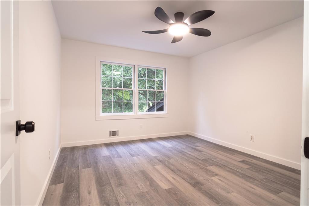 69 Hearn Road Ellenwood, GA 30294 - Photo 10 of 19 wooden floor in an empty room with a window