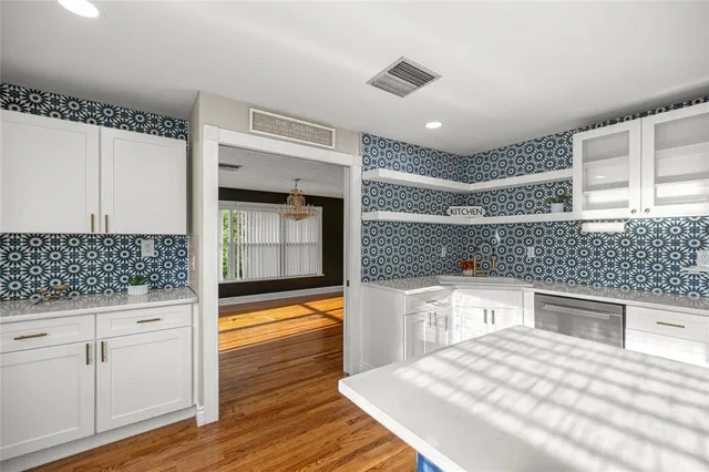 a view of an empty room with wooden floor