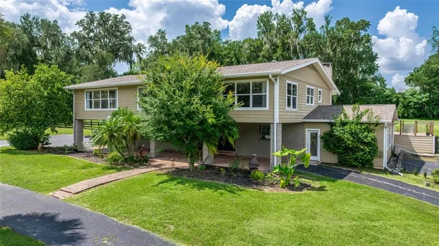 a view of a house with a flower garden