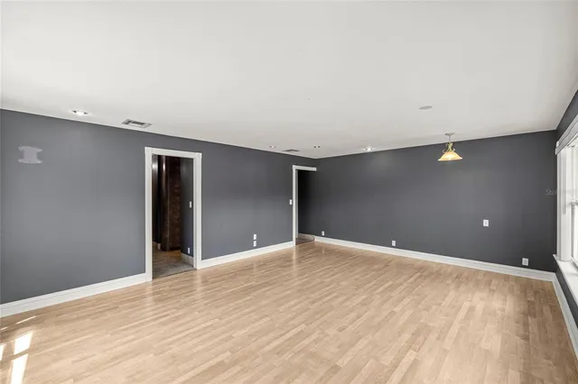 a view of a swimming pool with a patio and wooden floor