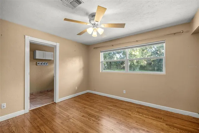 a view of a house with a big yard and sitting area