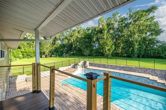 an aerial view of a house with yard swimming pool and outdoor seating