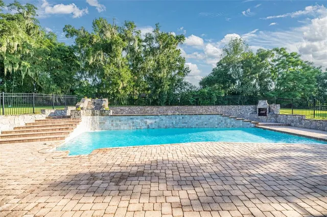 an aerial view of a house with a garden and trees